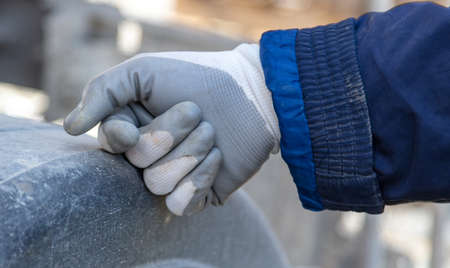 Worker's hand in a glove. Close-upの写真素材