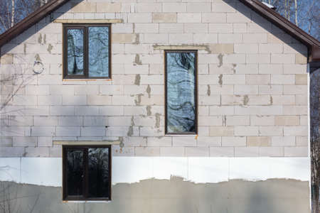A window in a brick house under construction.の写真素材