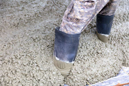 Worker feet in concrete mix at a construction site.の写真素材