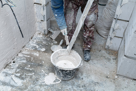 The man is plastering the walls in the house.の写真素材