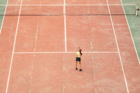 The girl plays tennis on the court.の写真素材
