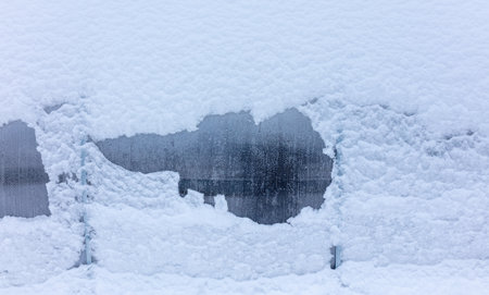 Snow on plastic glass as background in winter.の写真素材