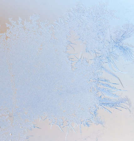 Snowflakes on glass as a background. Close-up