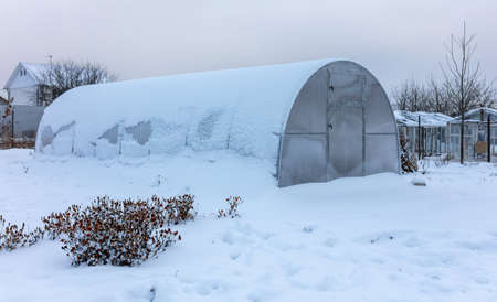 Greenhouse in the snow in winter.