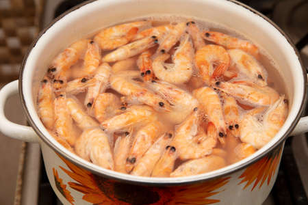 Red shrimps are boiled in a saucepan. Close-up.の写真素材