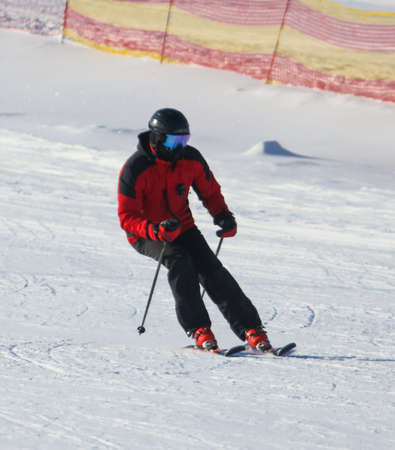 A man is skiing in the snow in winter.の写真素材