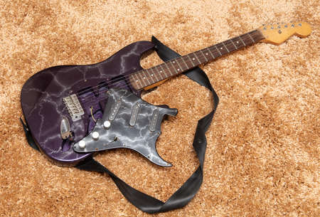 Broken electric guitar on the floor. Close-upの写真素材