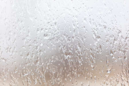 Frozen drops of water on a glass window as an abstract background. Textureの写真素材