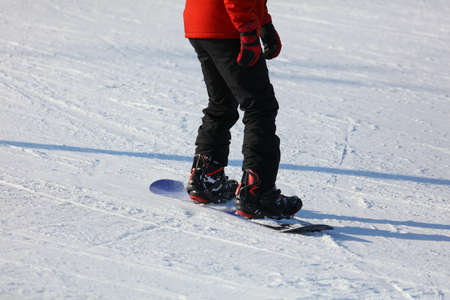 A man is snowboarding in the snow in winter.の写真素材