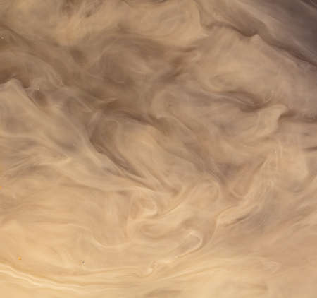 Muddy brown water in a puddle as an abstract background.