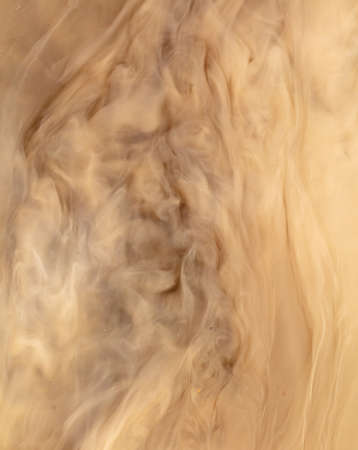 Muddy brown water in a puddle as an abstract background.の写真素材