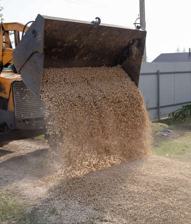 The tractor is working with rubble on the road. Construction