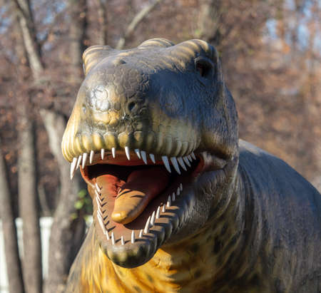 Portrait of an artificial dinosaur in the park. Close-up.の写真素材
