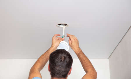 Installation of lighting on a stretch ceiling in a room.の写真素材