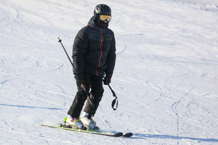 A man is skiing in the snow in winter.の写真素材