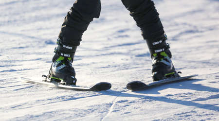 A man is skiing in the snow in winter.の写真素材
