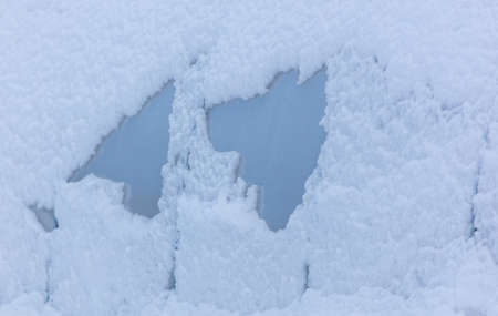 Snow on plastic glass as background in winter.
