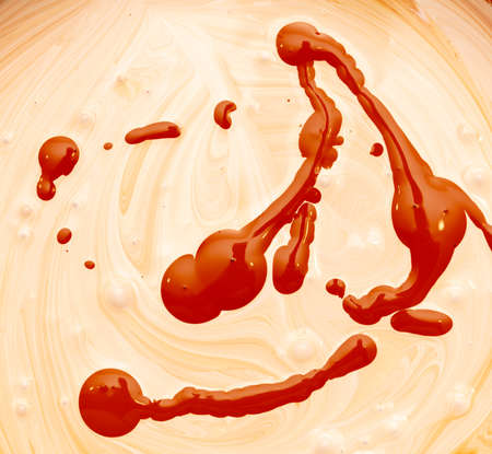 Mixing of red and white water-based paint. Abstract backgroundの写真素材