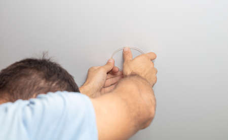 Installation of lighting on a stretch ceiling in a room.の写真素材