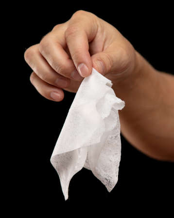 White napkin in hand on a black background.の写真素材