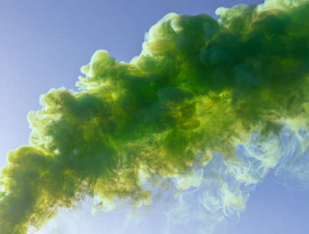 Green smoke on a blue sky background.の写真素材