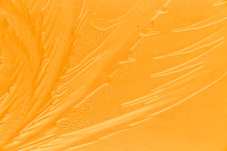 Gold patterns from frost on glass as a background. Close-up