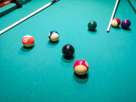 Balls and cue on the billiard table. Close-up