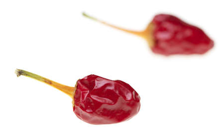 Red chili peppers on a white background. Macro
