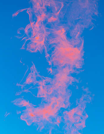 Red smoke on a blue sky background.