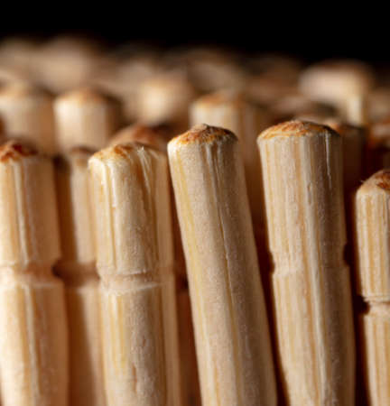 Close up of wooden toothpicks on a black background. Macroの写真素材