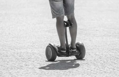 A man rides an electric hoverboard in the city.