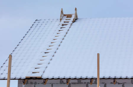 Snow on the roof of the house. Nature in winter
