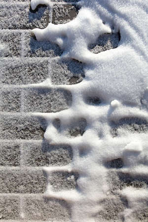 Paving slabs in the snow in winter. Backgroundの写真素材