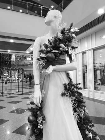 Mannequin of a girl in a dress on a showcase in the market. black and white photoの写真素材