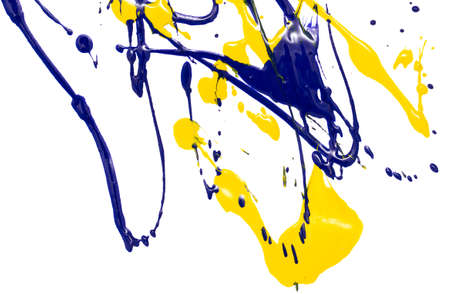 Drops of yellow and blue paint on a white paper background. Close-upの写真素材