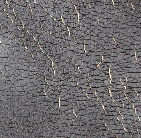Cracked leatherette on the armchair as a backdrop. Textureの写真素材