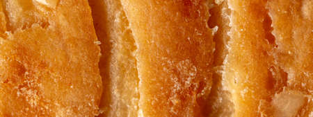 Golden crust of puff pastry as a background. Macroの写真素材