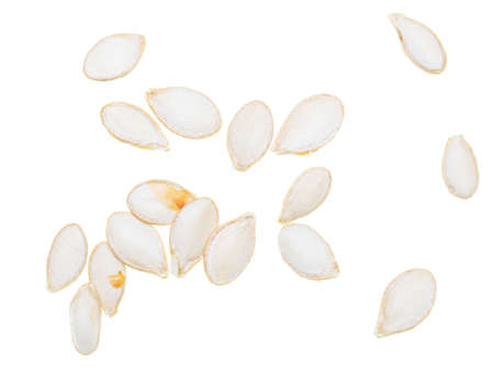 Close-up of pumpkin seeds on a white background.