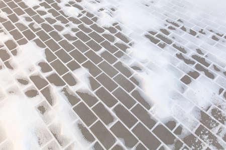 Paving slabs in the snow in winter. Backgroundの写真素材