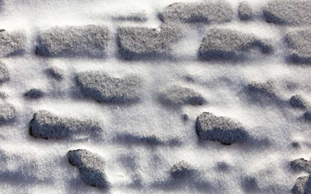 Paving slabs in the snow in winter. Backgroundの写真素材
