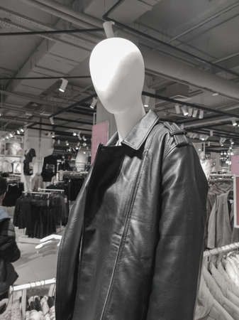 A mannequin of a man in a leather jacket on a display in a market. black and white photoの写真素材