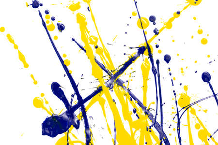 Drops of yellow and blue paint on a white paper background. Close-up
