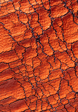 Cracked red paint on fabric as abstract background. texture