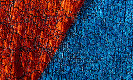 Cracked blue and red paint on fabric as an abstract background. Texture