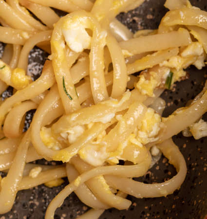 Noodles fried in a pan. close-upの写真素材