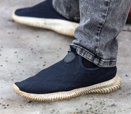 Men's feet in boots on the snow. close-up
