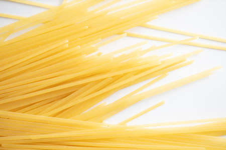 Dried long pasta isolated on white background. close-upの写真素材