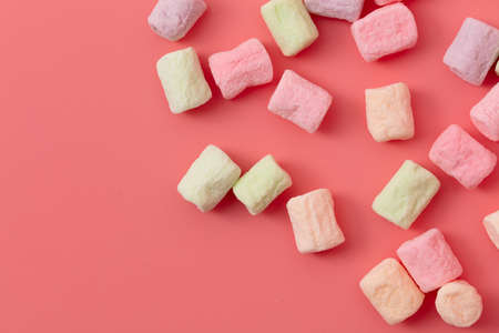 Multicolored candies on a pink background.の写真素材