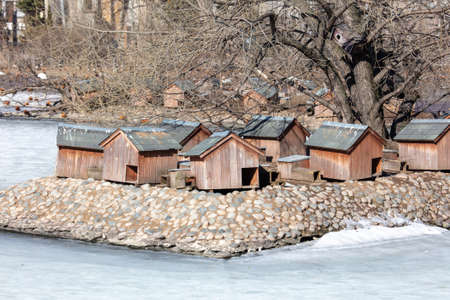 Duck house on the pond in the zoo in winter.