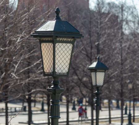 Lantern on a metal pole in the city during the day.の写真素材